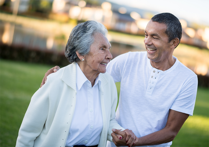 Mother and son standing together smiling